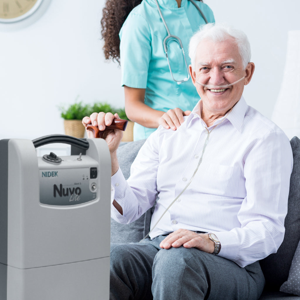 Man using a NIDEX Nuvo machine with a healthcare professional in the background